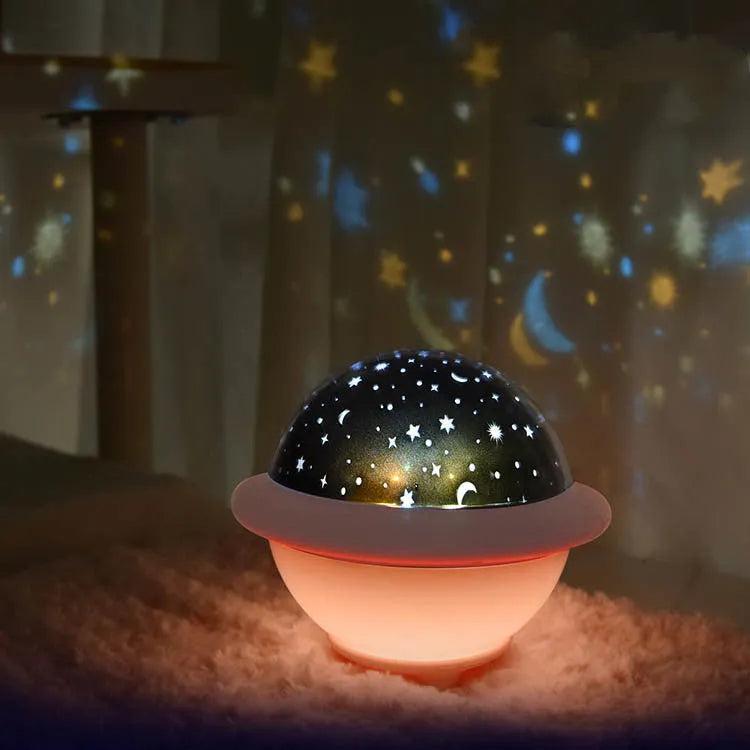 Green UFO-shaped starry sky projection light with button switch on a plastic base.