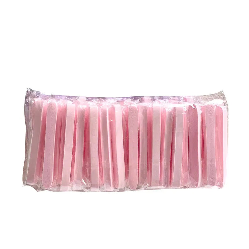 Compressed facial wipe puff in pink packaging, individually wrapped PVA sponge for single use cleansing
