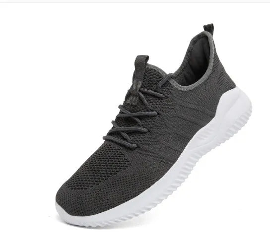 Men's black and white mesh sneakers with lace-up front and PVC sole on a plain background