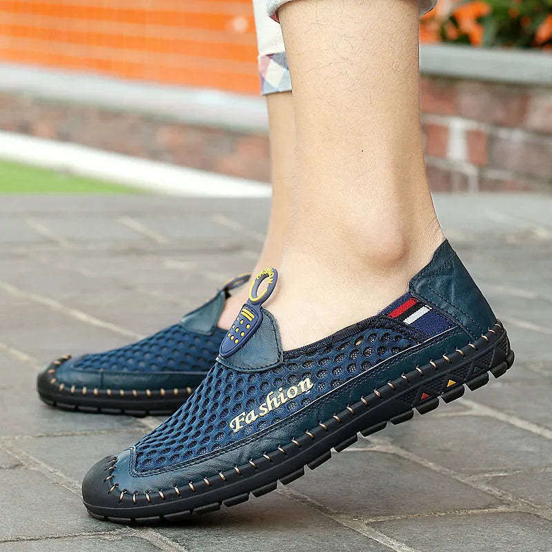 Men's brown casual shoes with mesh fabric upper and rubber sole, showing round toe and shallow-cut design.