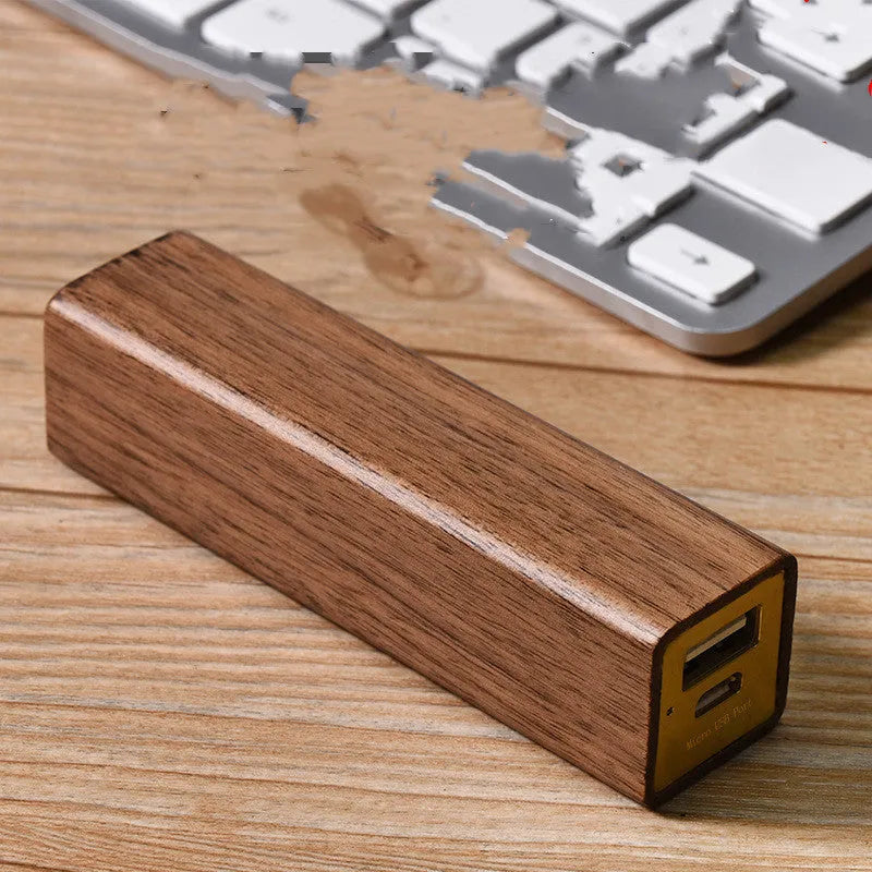 Solid walnut wood portable power bank with 2000mAh battery showing dimensions of 100mm x 25mm x 25mm