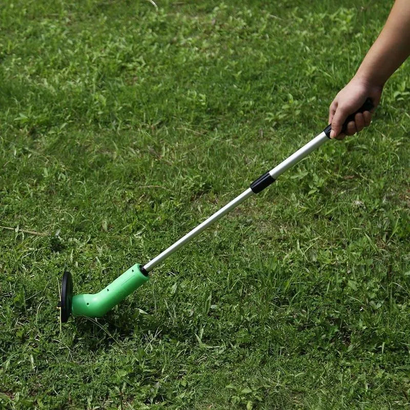 Cordless zip tie lawn trimmer with extension pole and protective debris shield on grass.