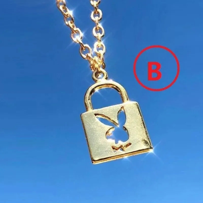Shiny alloy key lock pendant necklace with geometric shape and electroplated finish on white background