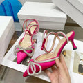 Women's black stiletto heel sandals with a silk bandage across the back and a buckle strap.