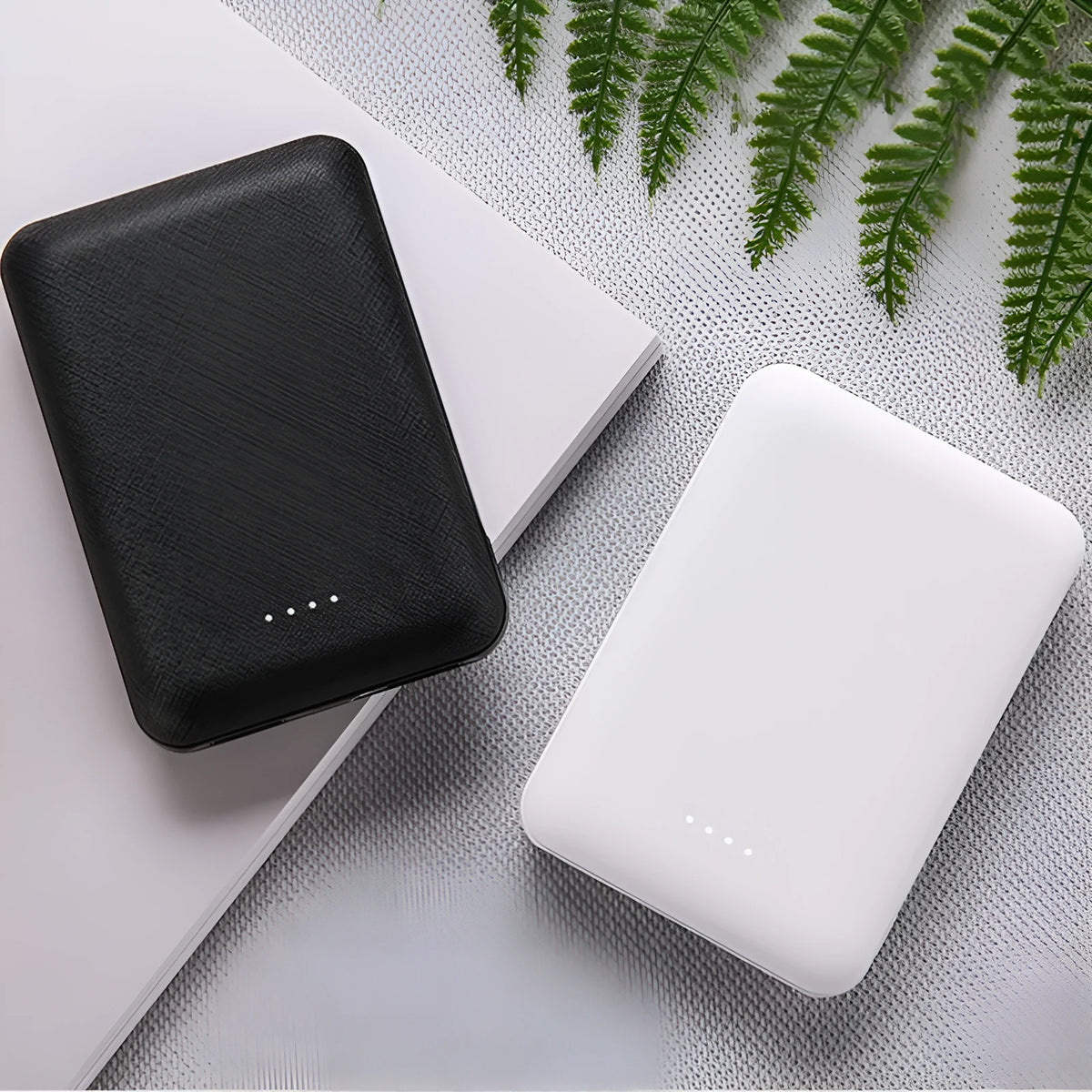 Black ultra-thin power bank showing dimensions 90x63x22mm with multiple USB ports