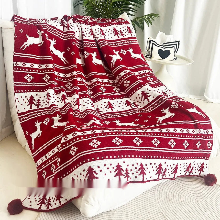 Personalised Christmas blanket with cartoon reindeer pattern, folded to show its soft acrylic texture.