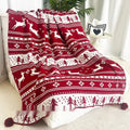 Personalised Christmas blanket with cartoon reindeer pattern, folded to show its soft acrylic texture.