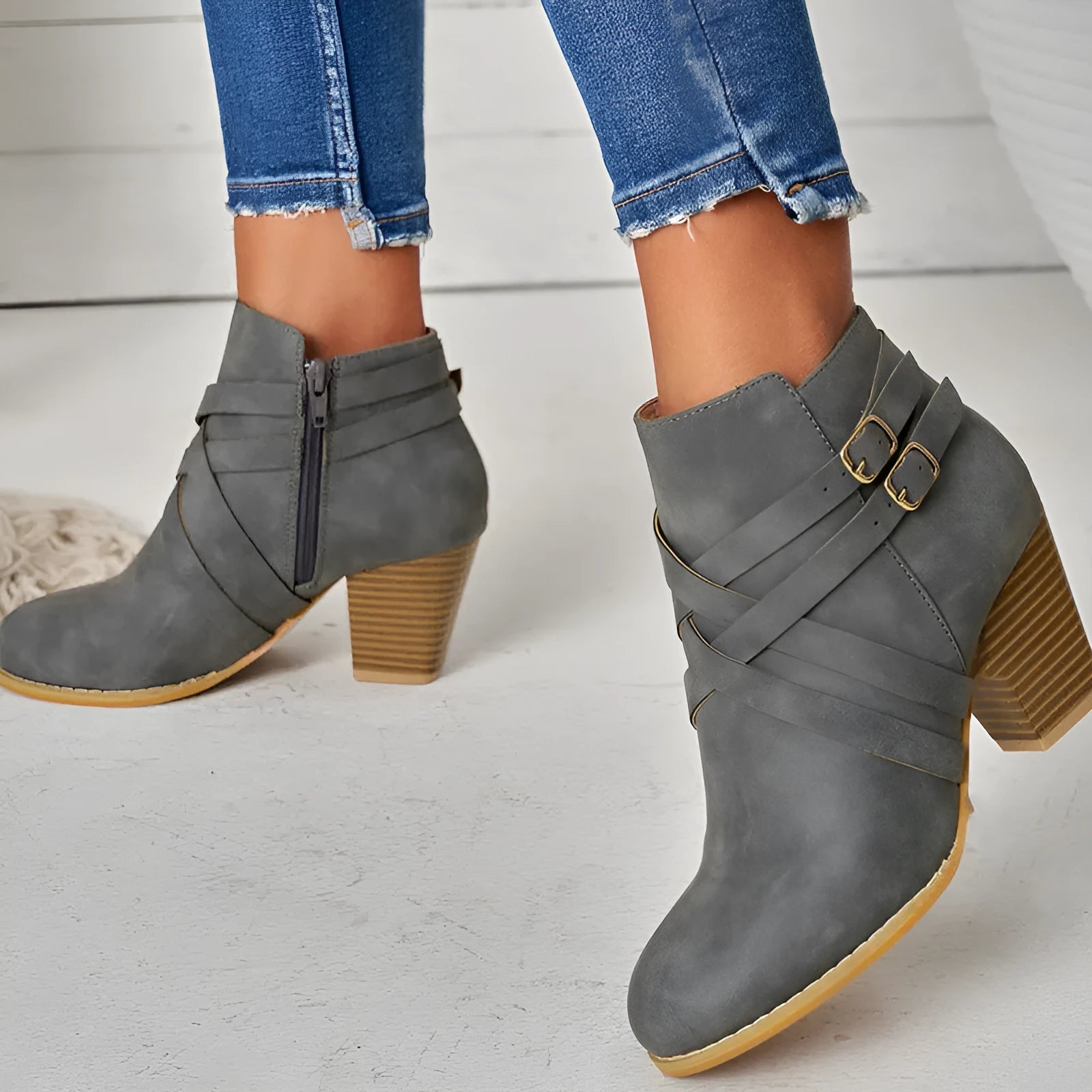 Women's grey PU leather short ankle boot with side zip, buckle strap, and a thick 7cm rubber heel.