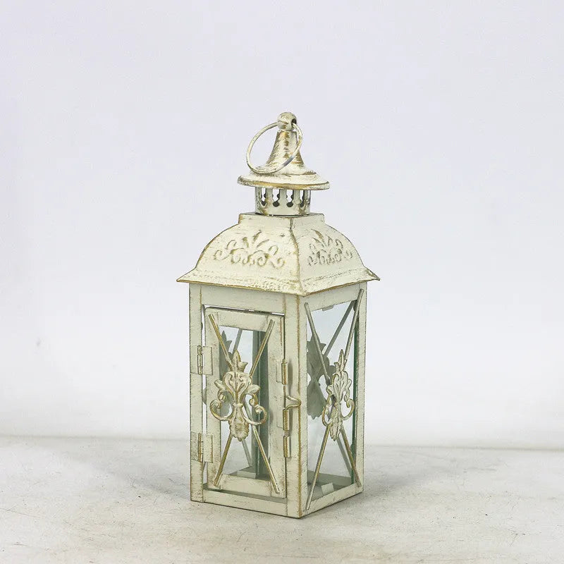 Black and white wrought iron floor-standing storm lantern with tempered glass panels in three sizes for courtyards.