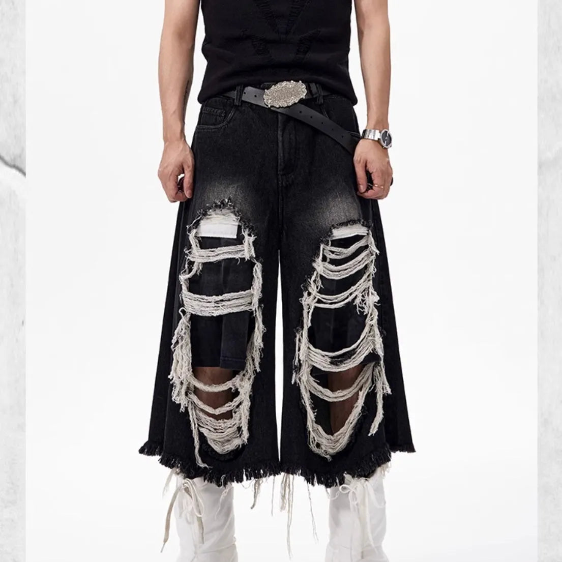 Black women's cropped wide-leg jeans with a ripped patch detail on the leg.