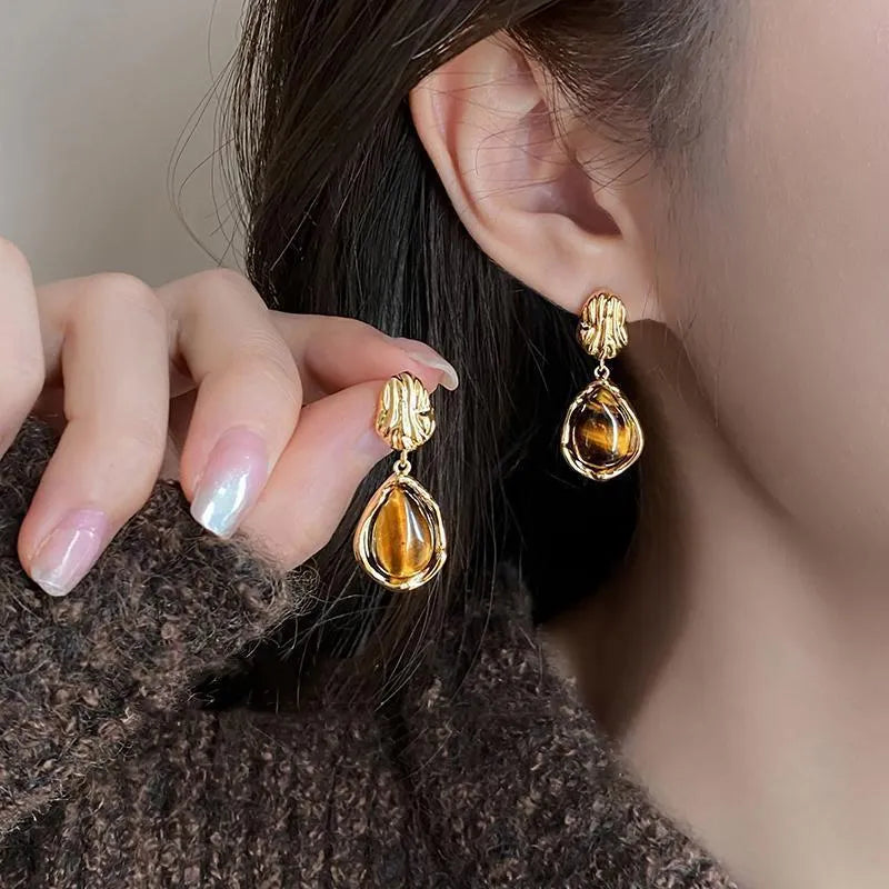 Handmade geometric holiday ear ring set showing three styles with tassel elements in different designs