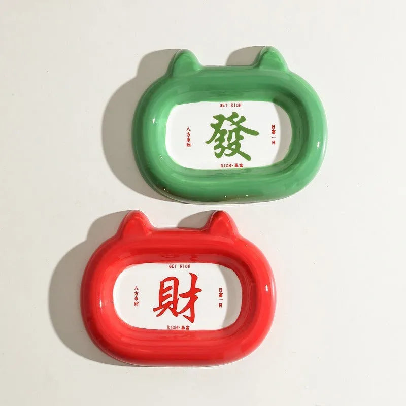White ceramic pet bowl with raised sides featuring a colourful cai wealth character design for cat or dog food and water