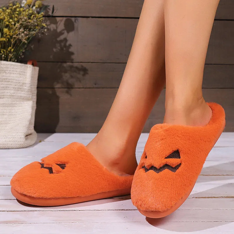 Orange Halloween pumpkin design slippers with plush lining and a textured PVC sole.