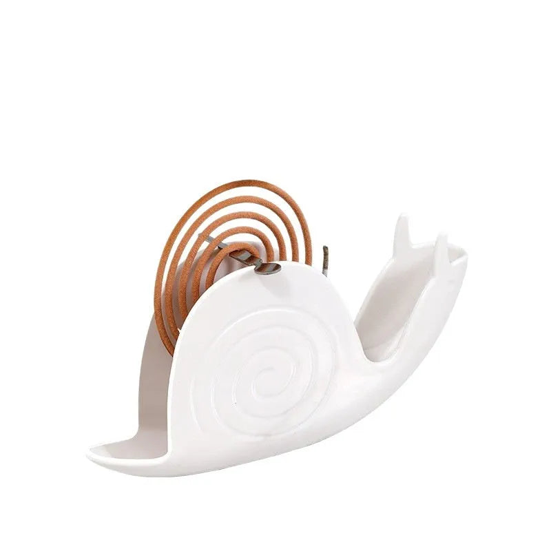Black plastic mosquito incense holder with creative animal style on a flat surface