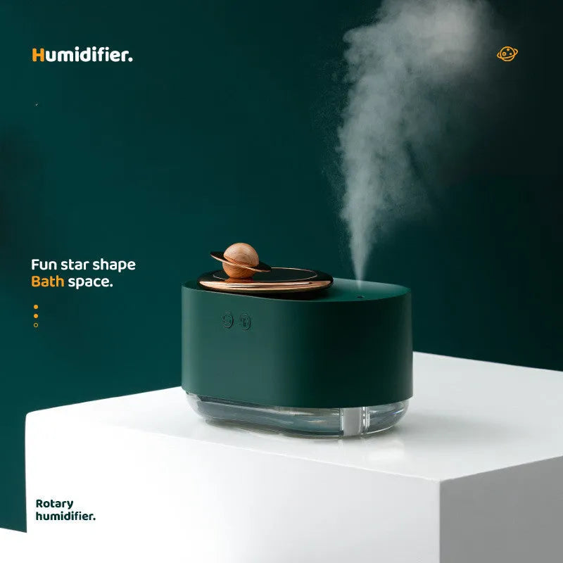 Green rotating planet USB humidifier with night light on wooden surface