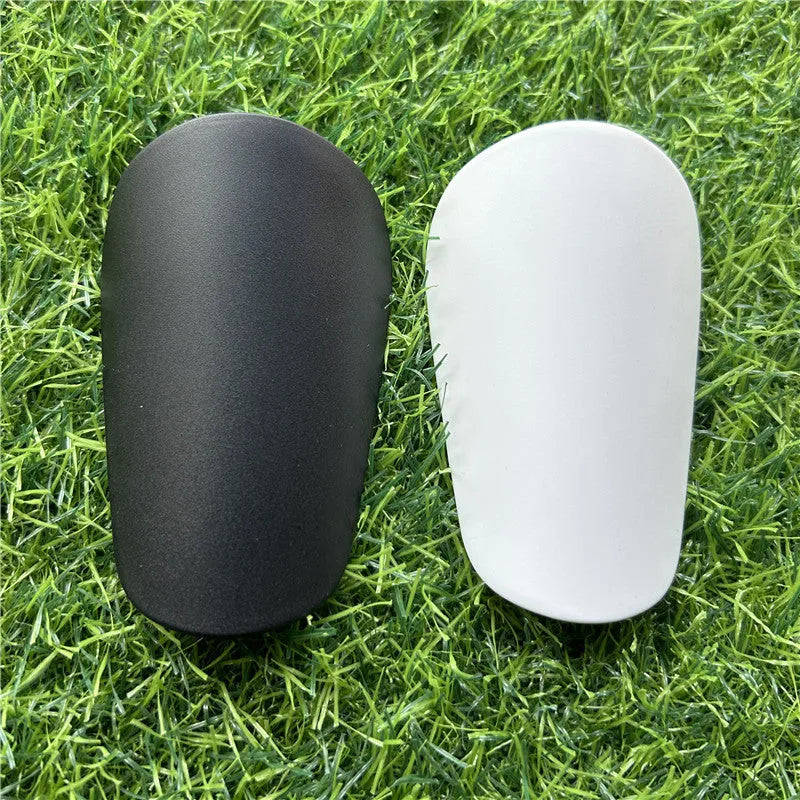 Extra small mini football shin guards in black and white measuring 8cm by 5cm
