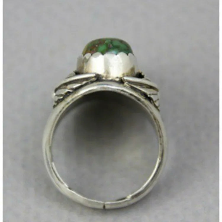 Women's retro geometric alloy ring with a turquoise inlaid design, shown on a finger.