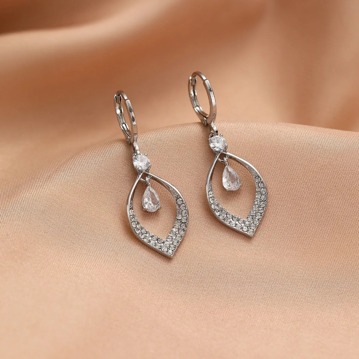 A pair of women's zircon water drop tassel earrings in a teardrop shape with gold-coloured buckles.