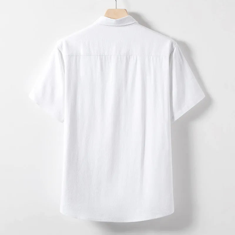 Man modelling a loose-fit linen blend T-shirt in a solid colour.