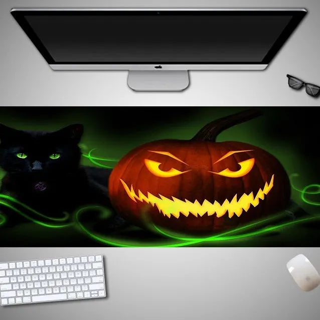 Oversized Halloween-themed computer mouse pad with non-slip rubber cloth backing on wooden desk