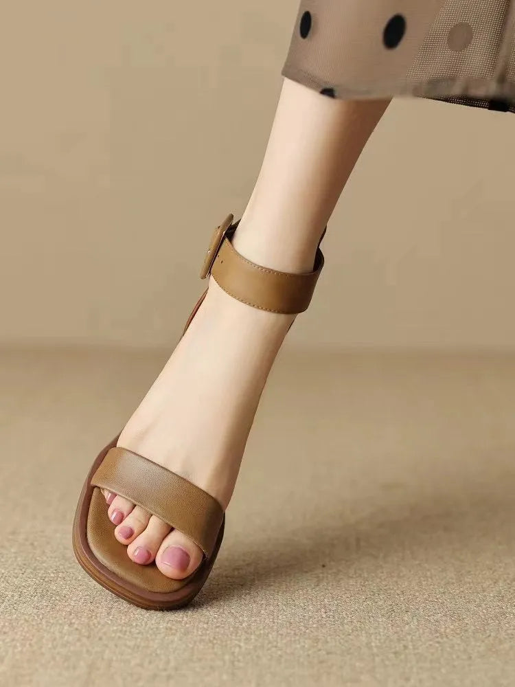 Women's white retro ankle-strap platform high heels with a round toe on a plain background.