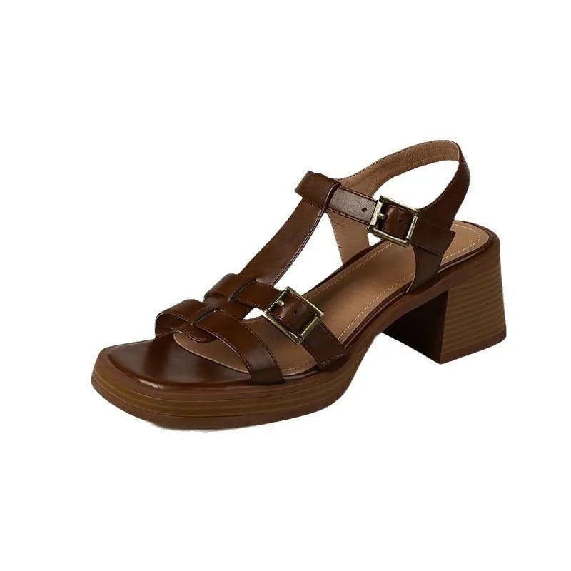 Women's black retro platform sandals with chunky heel and T-buckle strap on a white background.