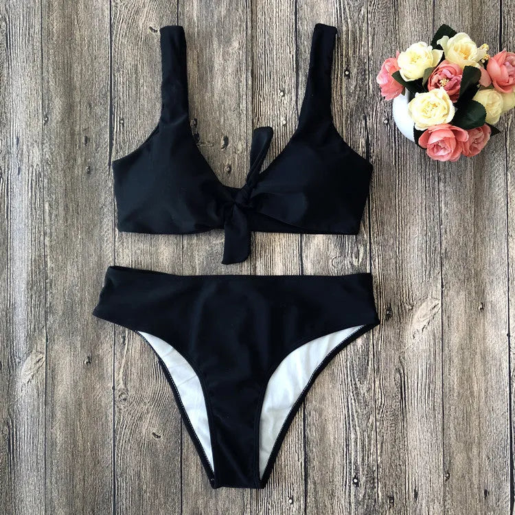 Solid colour bikini set on hanger, showing bra top and briefs in black, pink, red, white, or wine red.