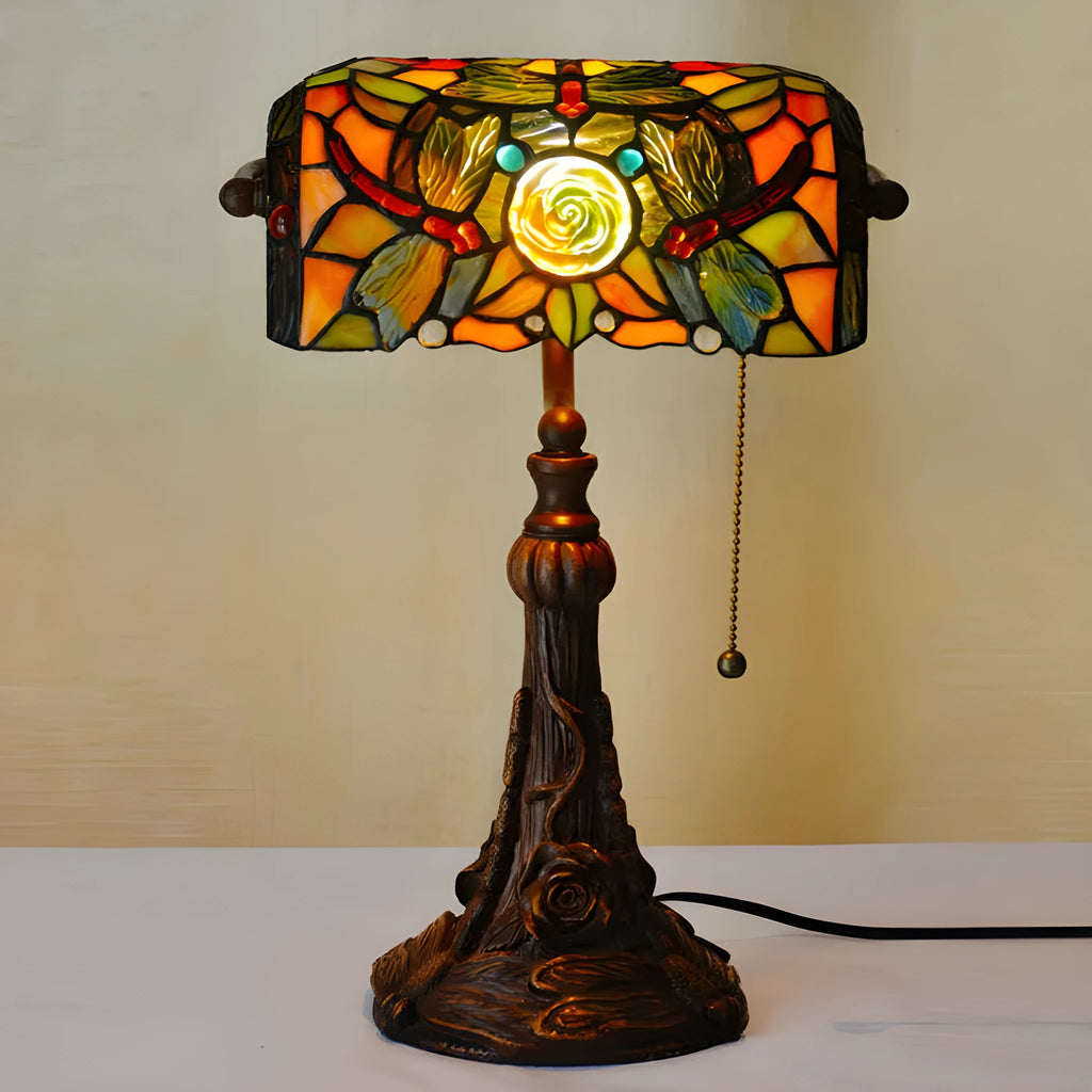 10-inch tall Tiffany table lamp with multi-coloured stained glass shade on a resin base.