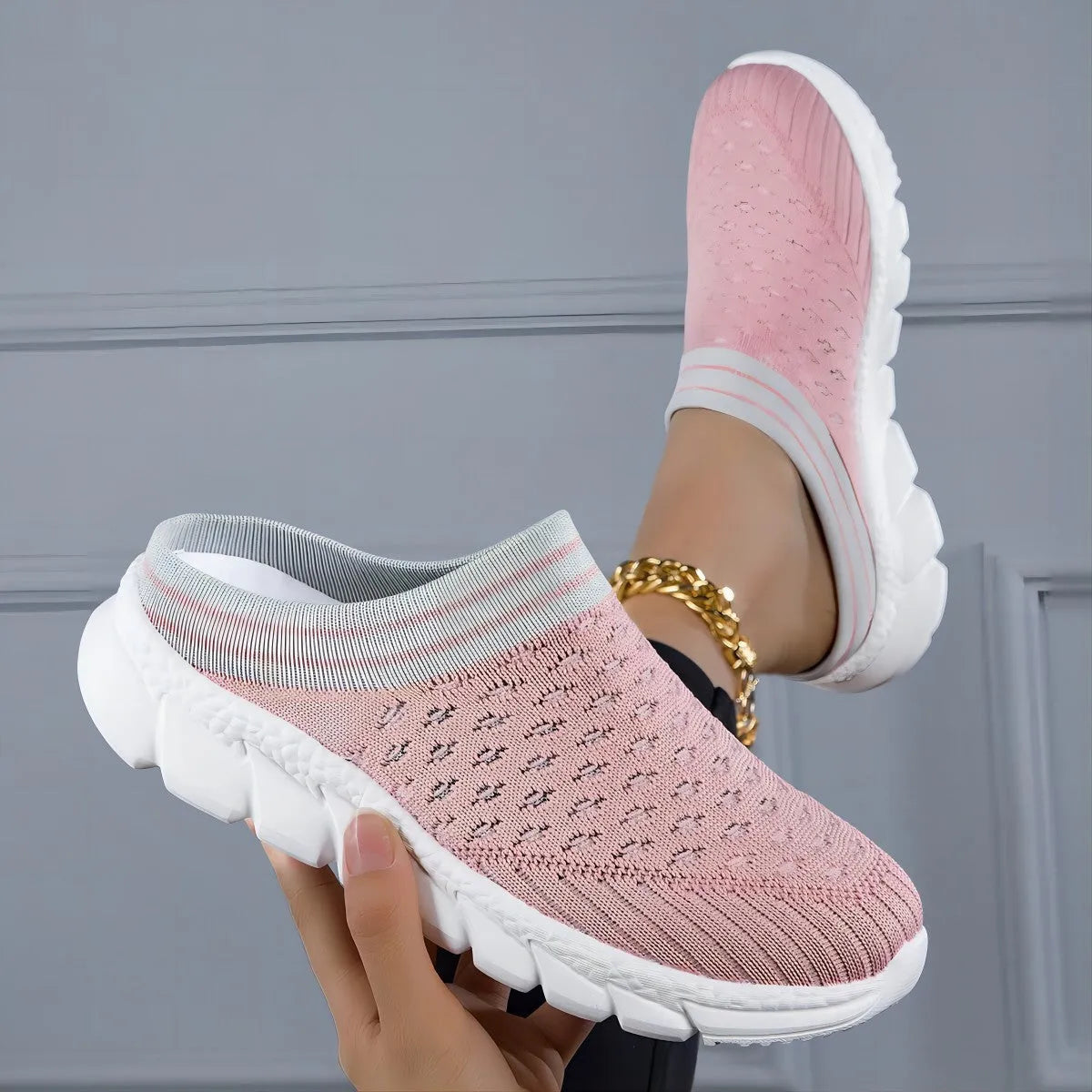 Women's black Flyknit semi-slipper shoe with striped pattern and raised sole