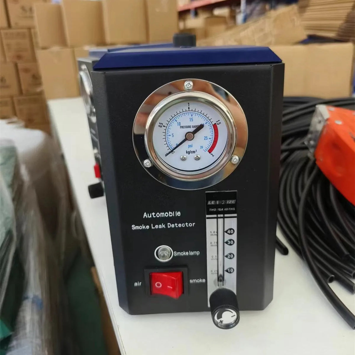KT9105 English specification steel car smoke leak detector on a workshop bench.