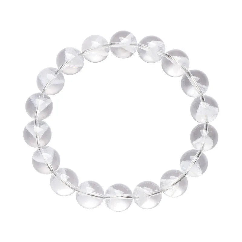 Women's white crystal bracelet with ghost pyramid beads and a ruyi charm, shown on a wrist.