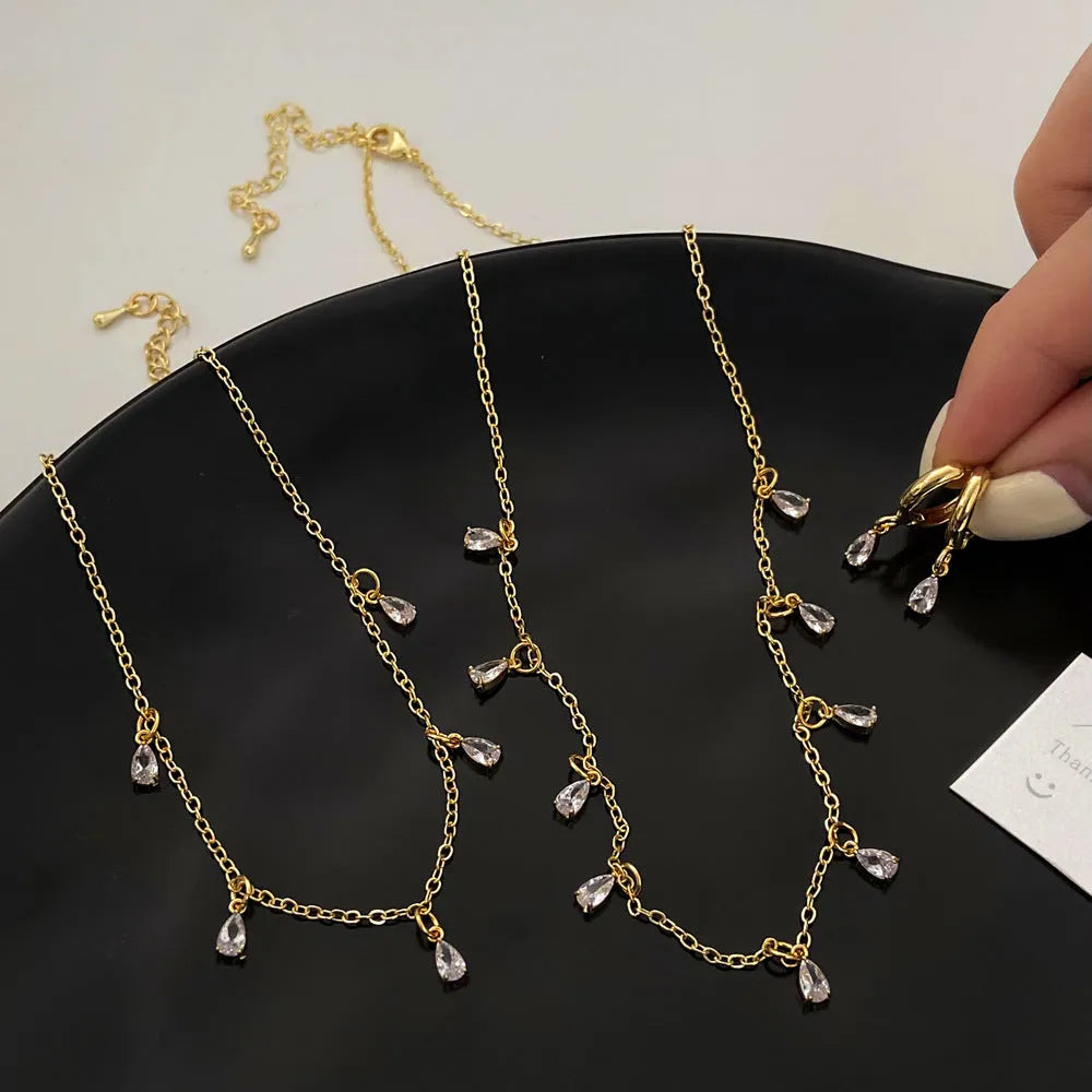 Zircon jewellery set with geometric meteor shower design including necklace, earrings and anklet