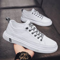 Men's white casual shoes with round toe, flat bottom, and shallow opening