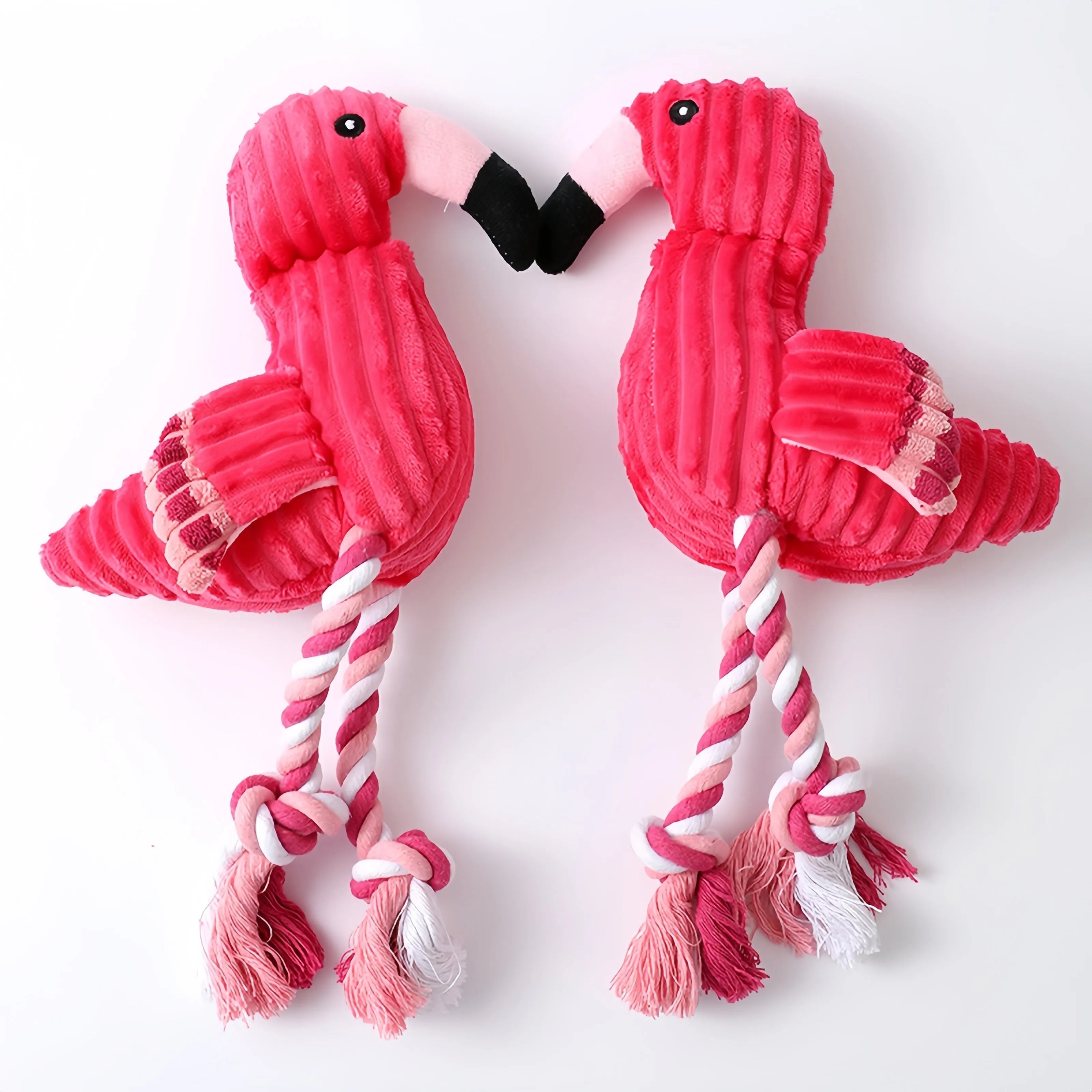 Pink corduroy animal-shaped plush dog toy with squeaker on a neutral background.