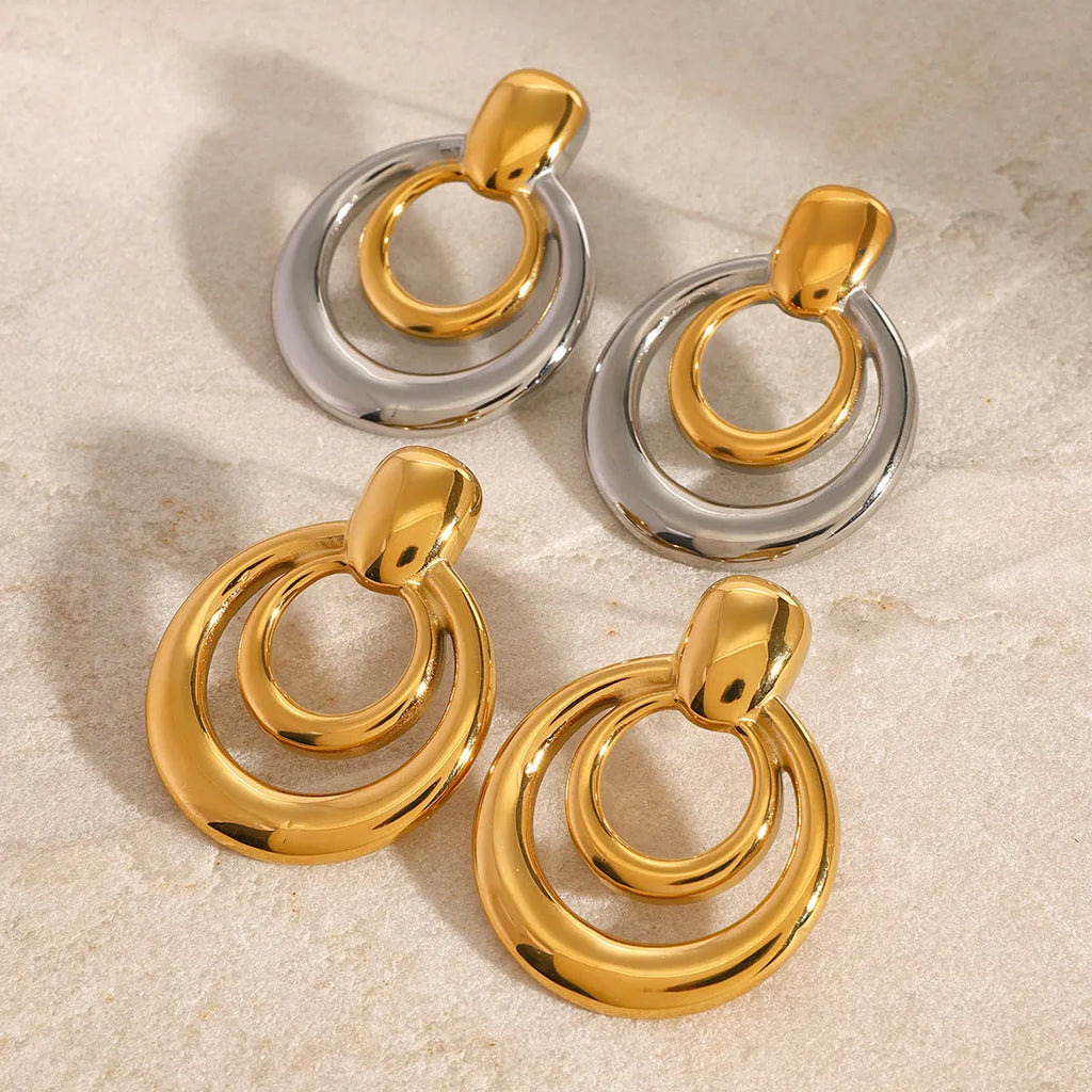 Golden electroplated titanium steel hollow geometric stud earrings showing double layer round design