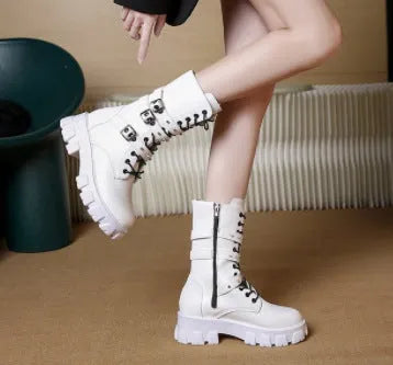 Women's black mid-calf buckle boots with side zipper and round toe, showing metal buckle detail