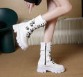 Women's black mid-calf buckle boots with side zipper and round toe, showing metal buckle detail