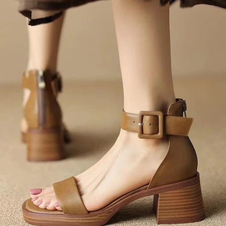 Women's white retro ankle-strap platform high heels with a round toe on a plain background.
