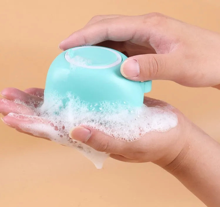 Silicone dog bath and massage brush in blue, pink, and yellow colours on a white background