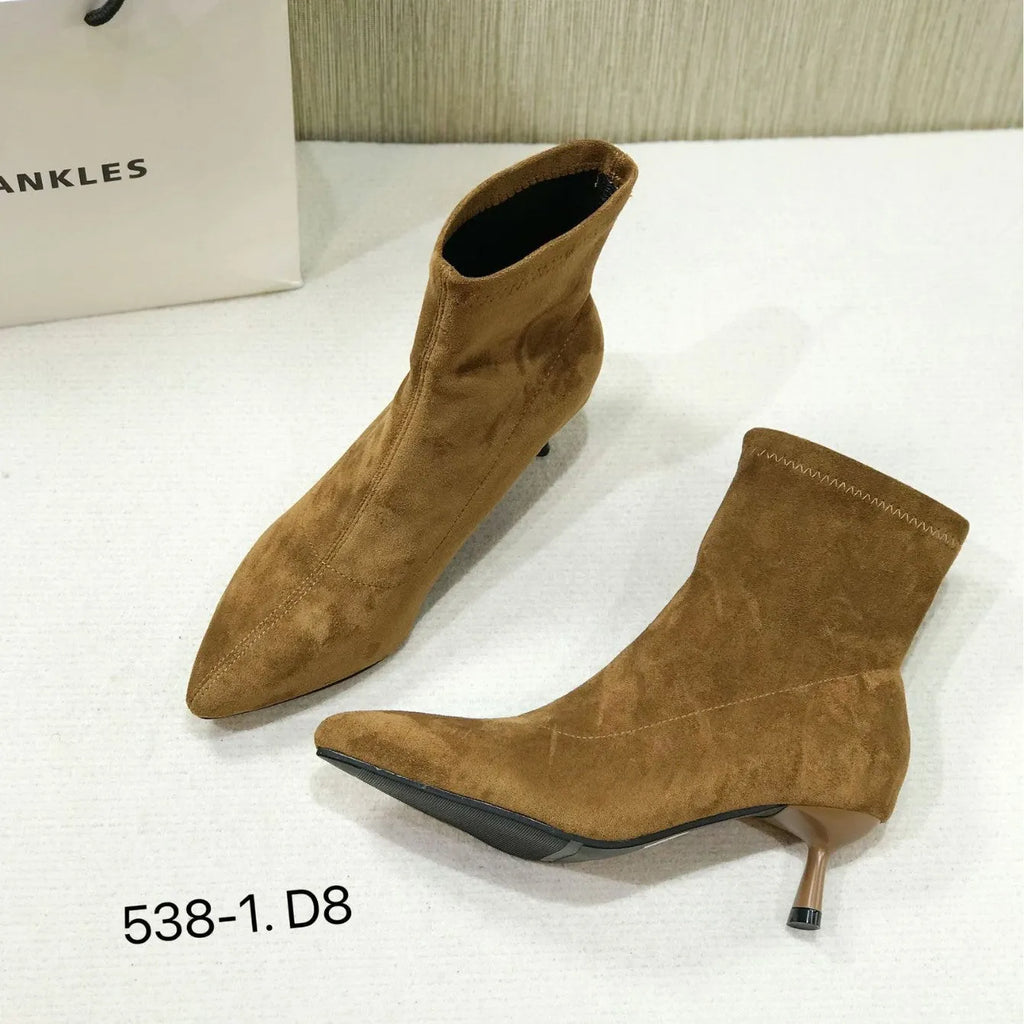 Black pointed toe women's ankle boot with high stiletto heel and mid-calf shaft on a plain background.