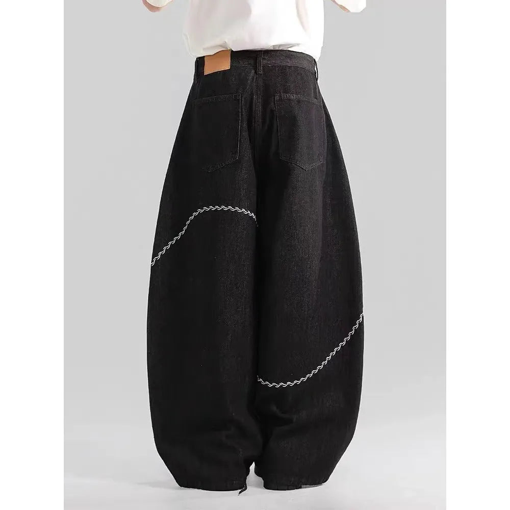 Black straight-leg men's trousers with a mid-waist and zip fly on a hanger.
