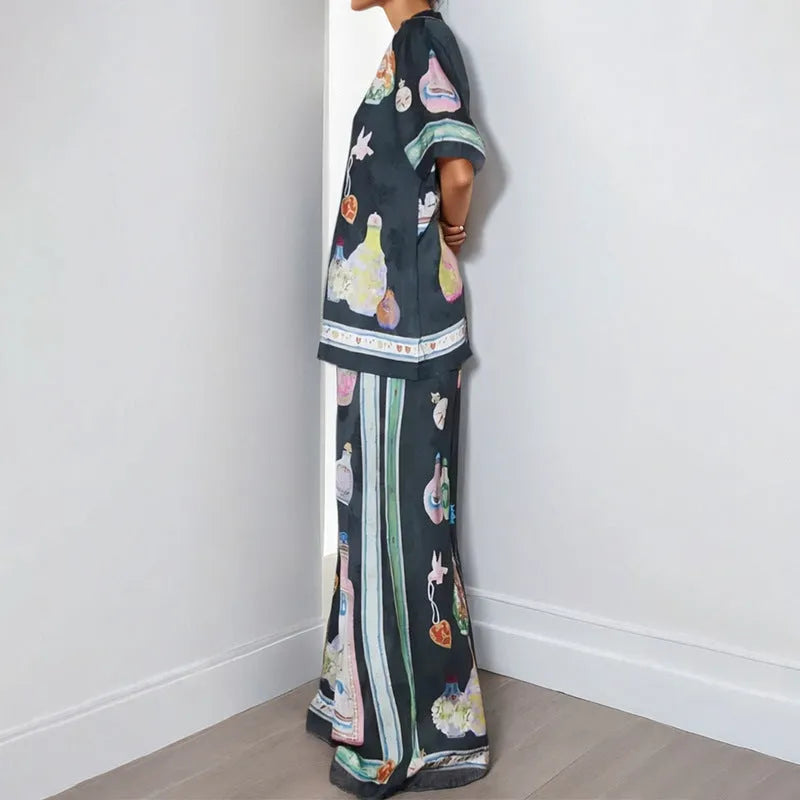 Black women's casual set with cartoon pattern, featuring a short sleeve cardigan and matching trousers.