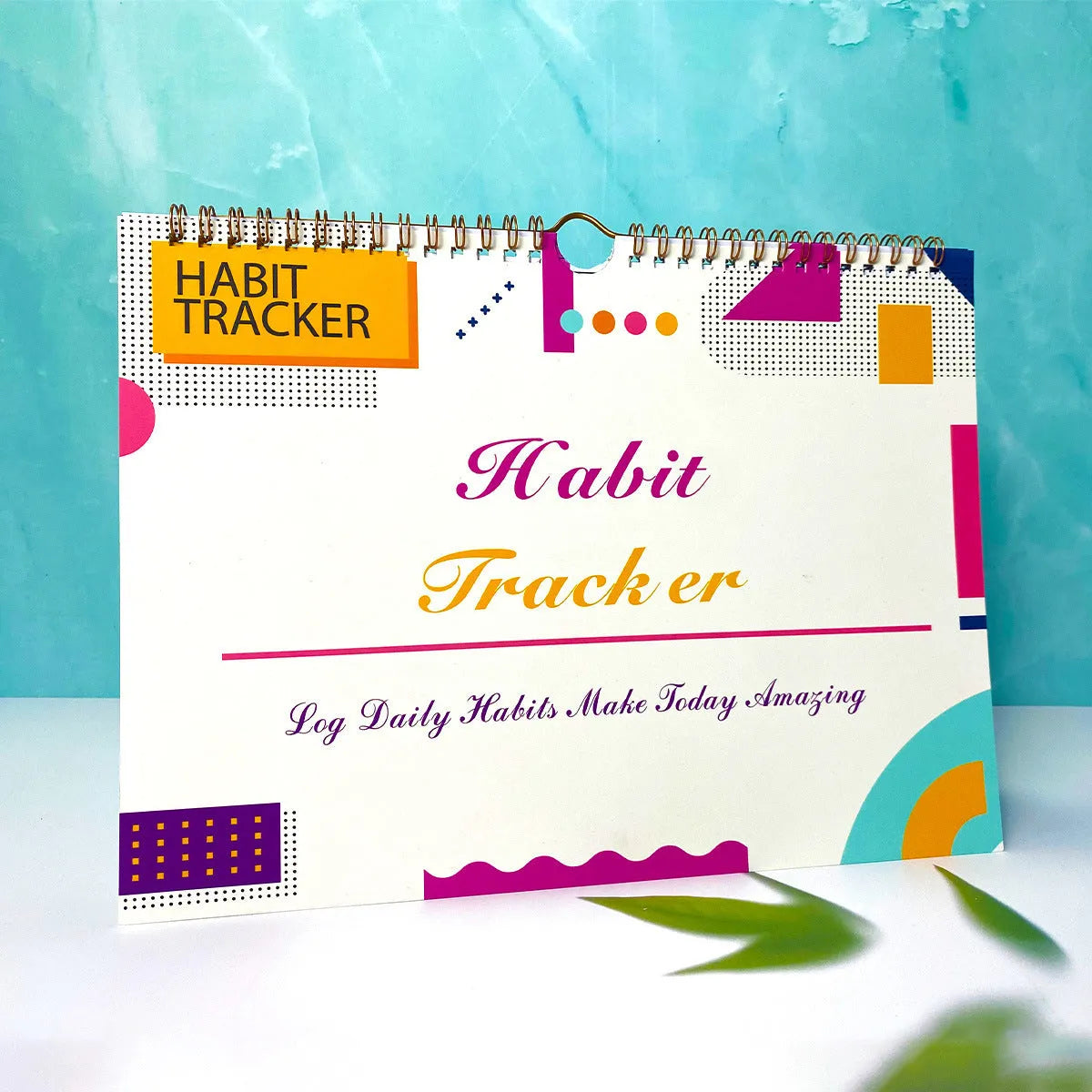 12-page habit tracking journal in pink and white, showing its 21cm by 28cm size.