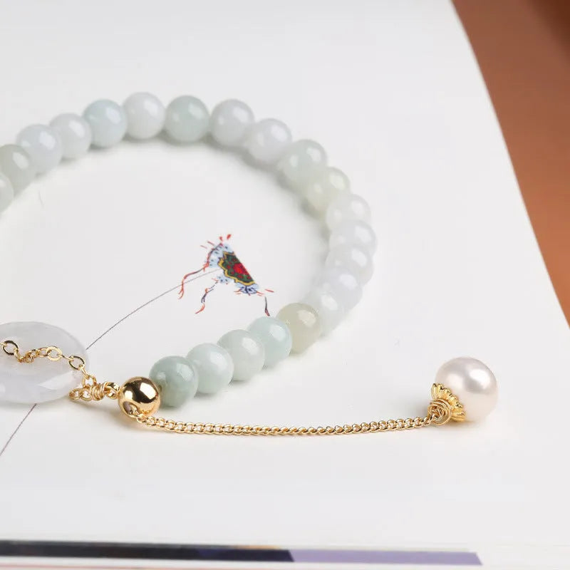 Natural green jade and pearl bracelet with peace buckle closure on wrist