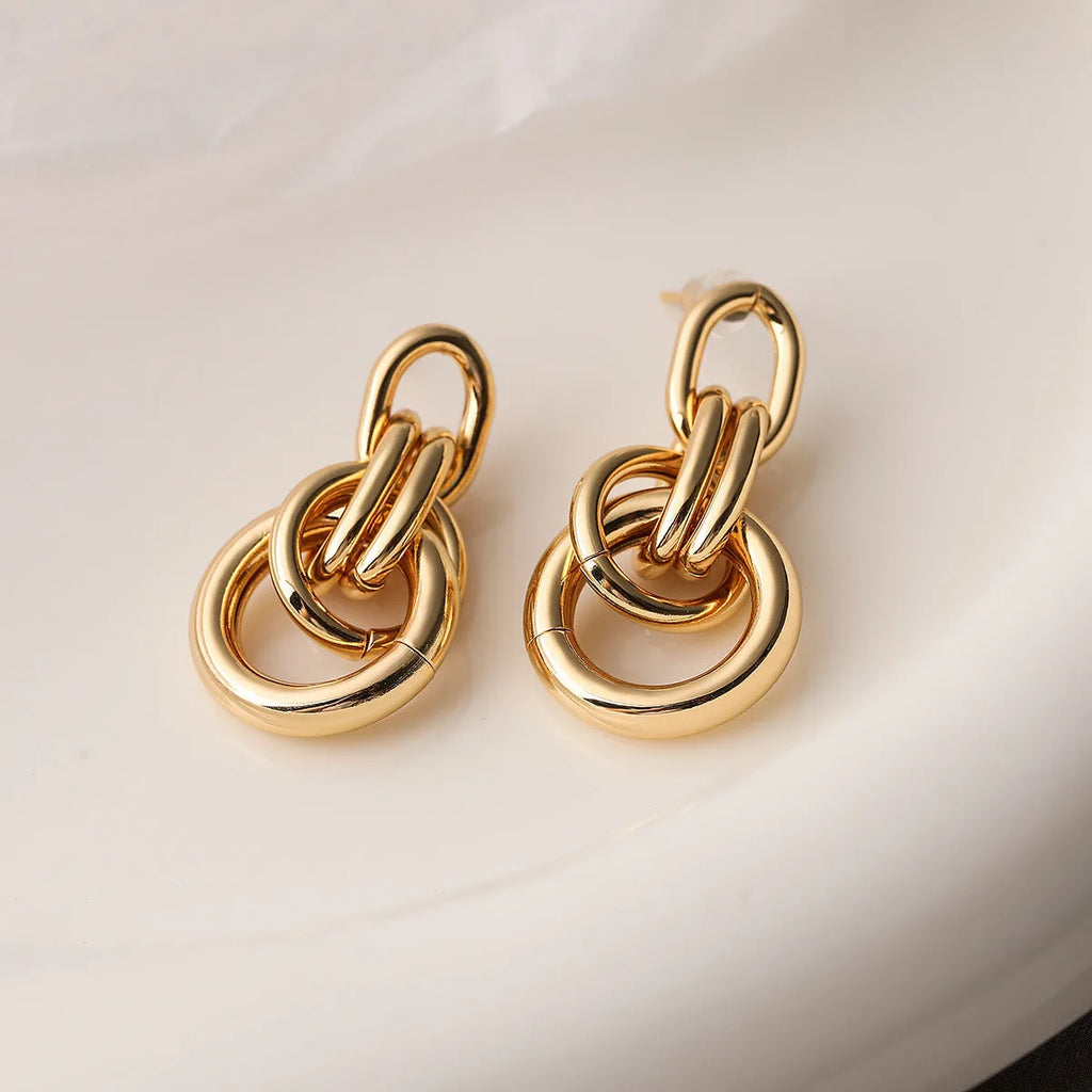 Geometric gold-colour copper earrings with irregular asymmetric design for women