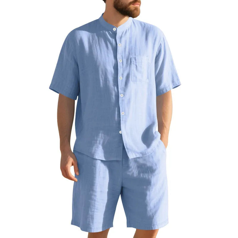 Man wearing a light blue short sleeve linen shirt jacket and matching shorts, a two-piece summer suit.