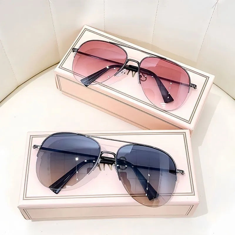 Aviator-style sunglasses with a metal frame and tinted resin lens, shown in a gold frame variant.
