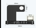 Foldable wireless charging station showing alarm clock display, RGB night light, and phone charging surface
