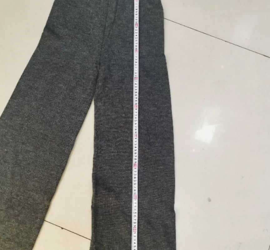 Women's acrylic suit with side-slit sweater top and matching trousers in solid colour