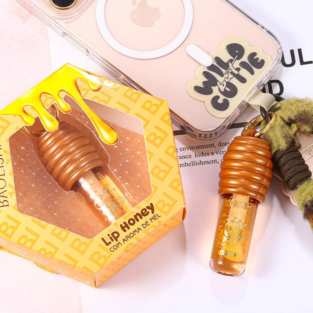Honey coloured lip gloss with keychain attachment for bags